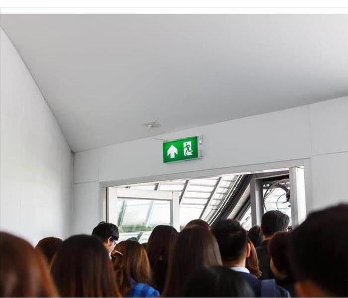 People escaping through an exit door